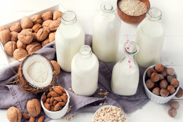Alternative types of milks in glass bottles. Vegan non dairy milk